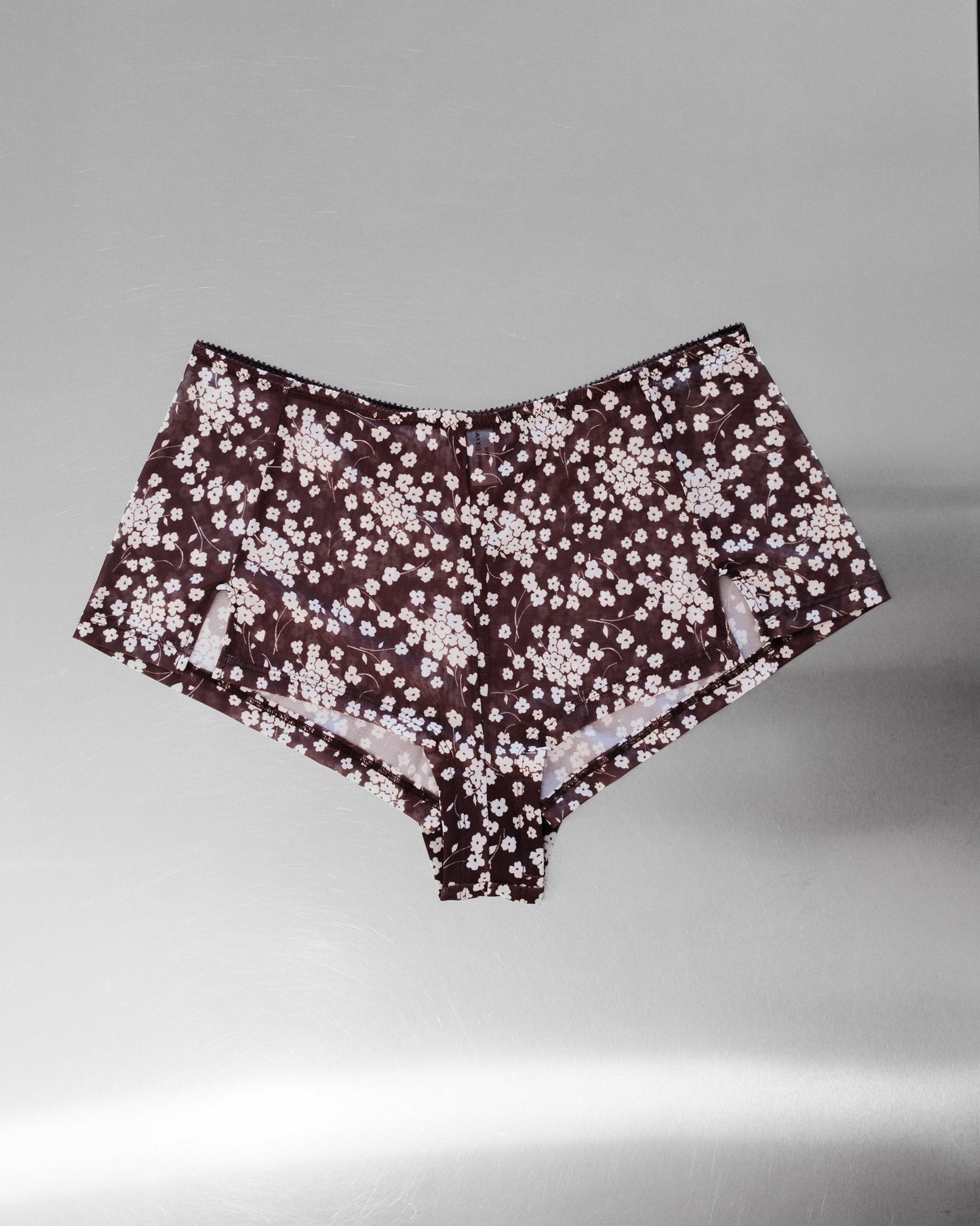Floral Mesh Shorts on grey background