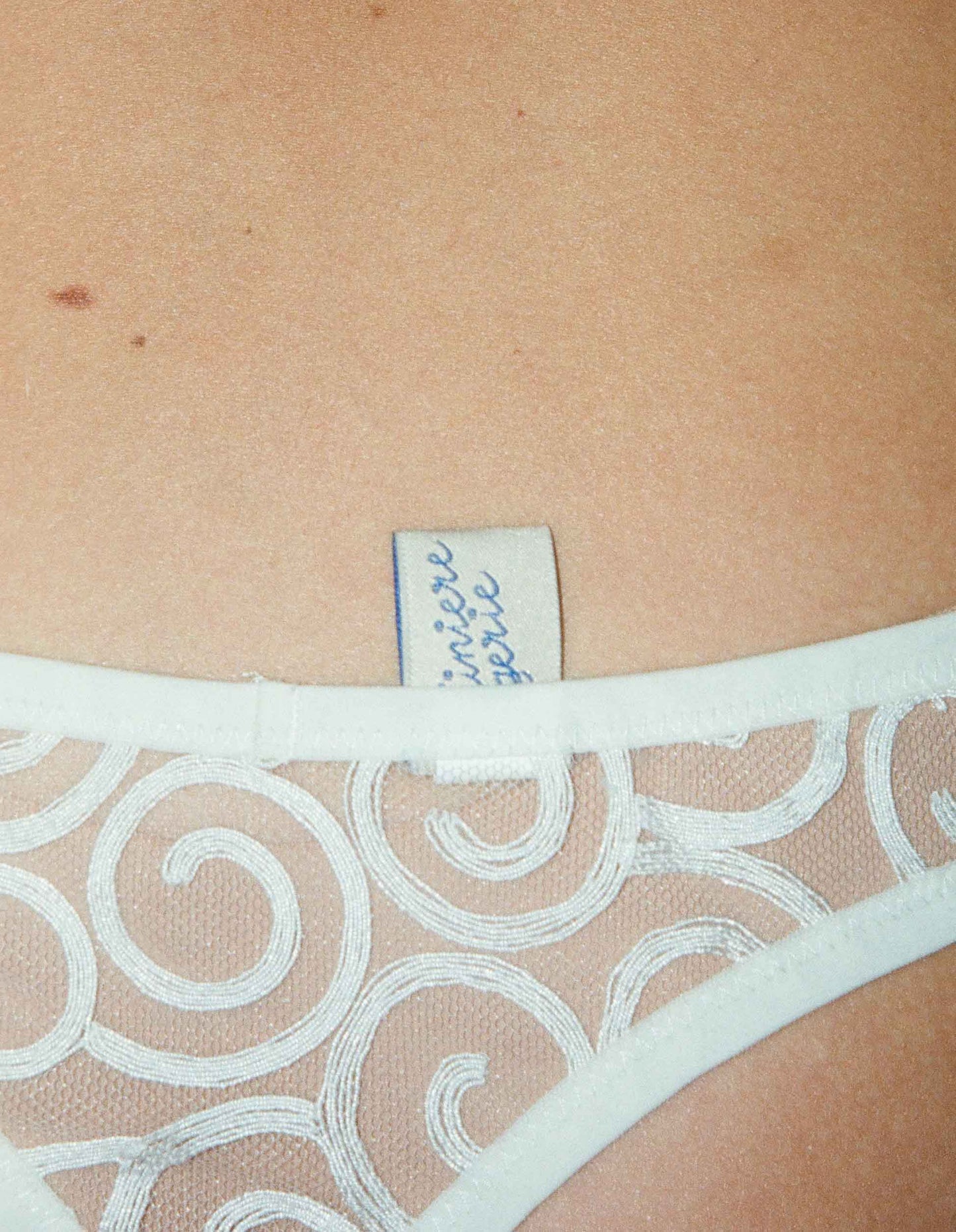 An ivory-colored, floral patterned brief