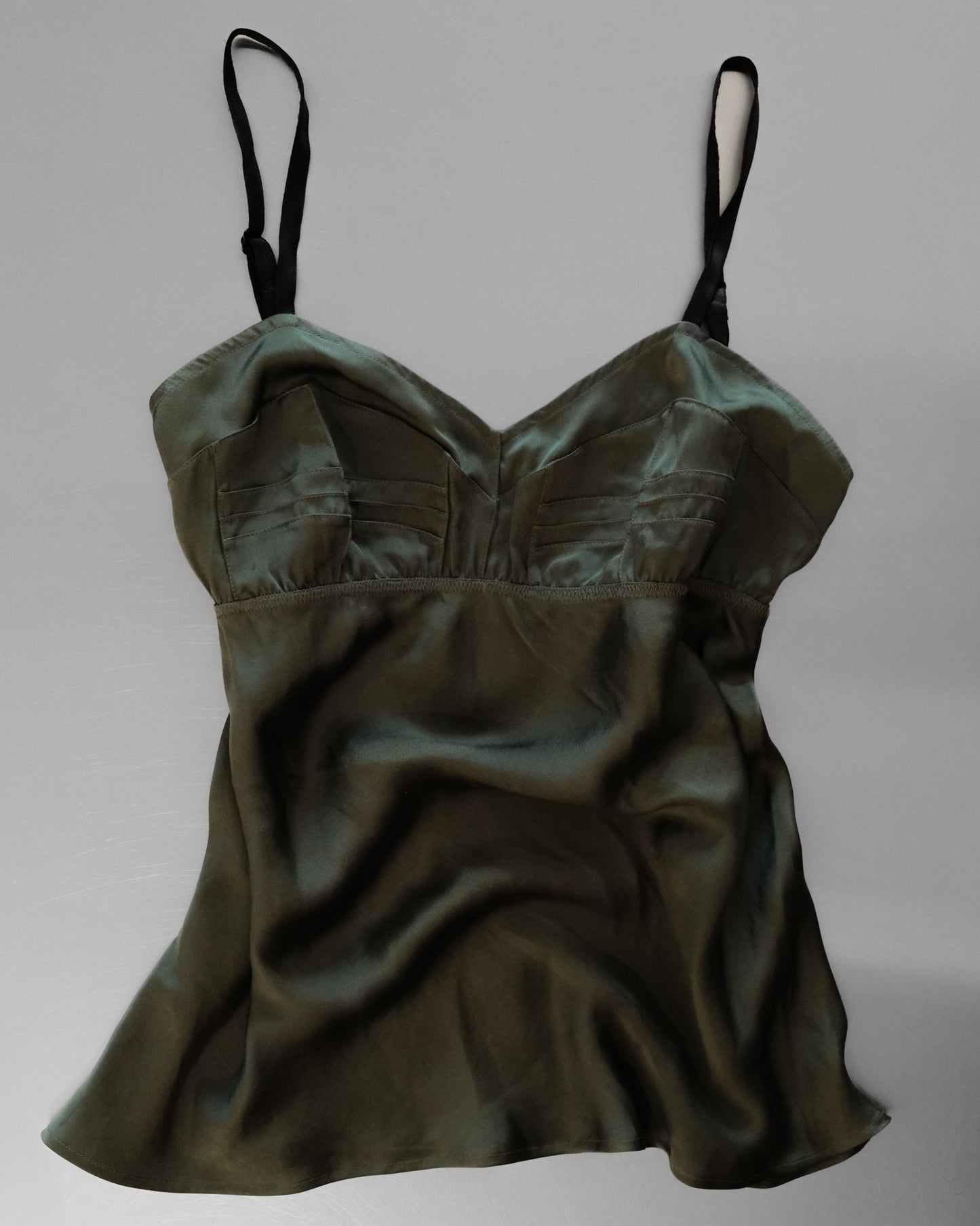 Green satin camisole on a gray background