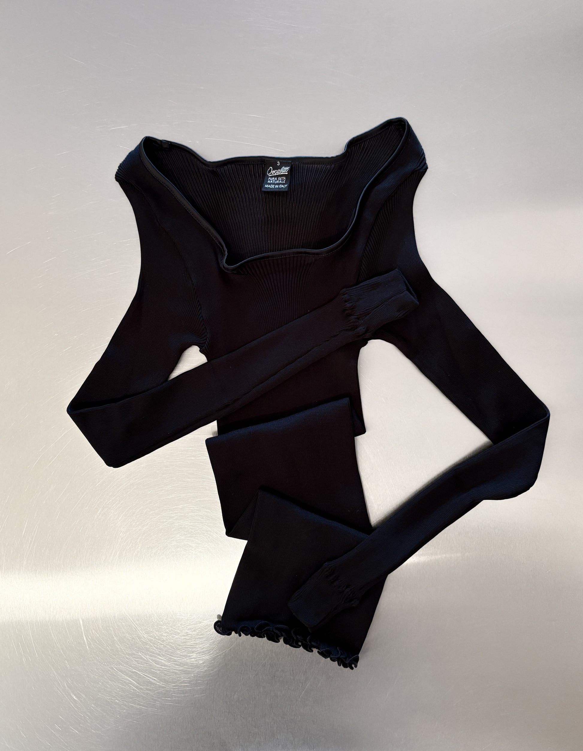 Silk Black Long Sleeve on a table