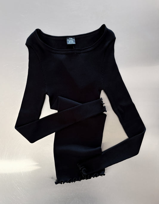Black long sleeve top on table
