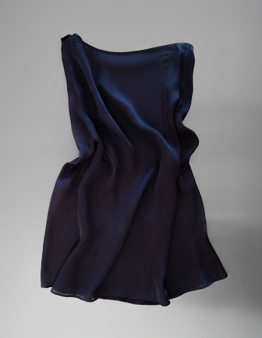 Navy blue slip skirt on a gray background
