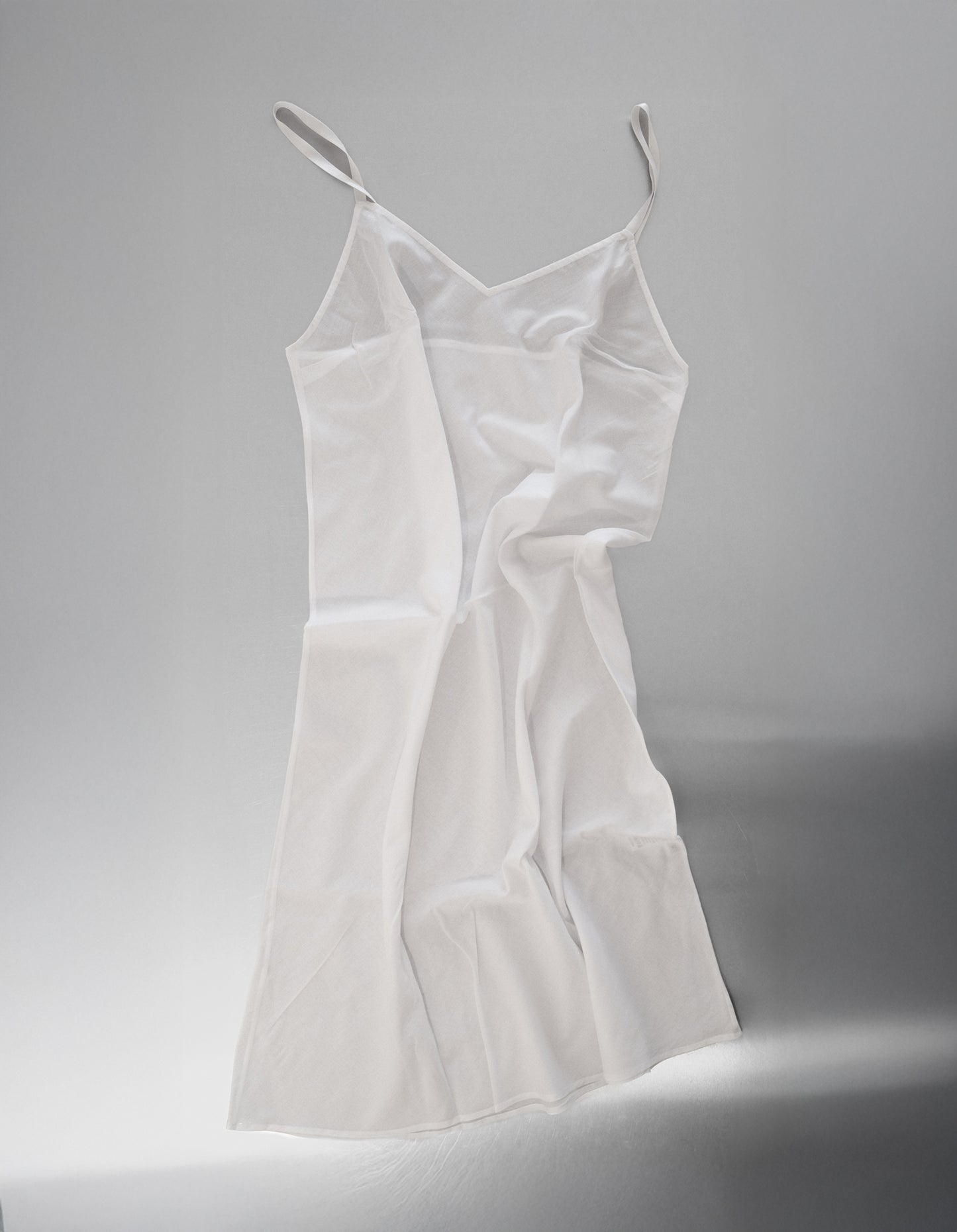 White slip dress on a white background