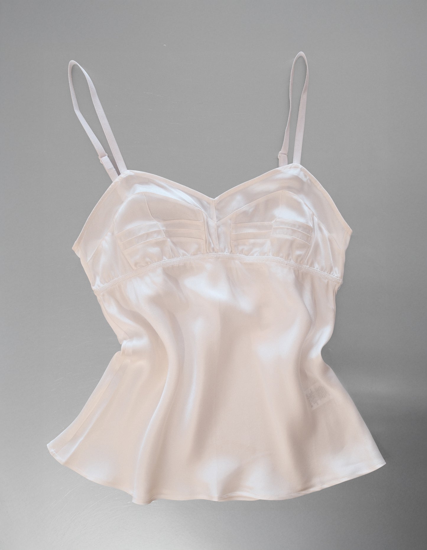 White Cami with white straps on a metal table