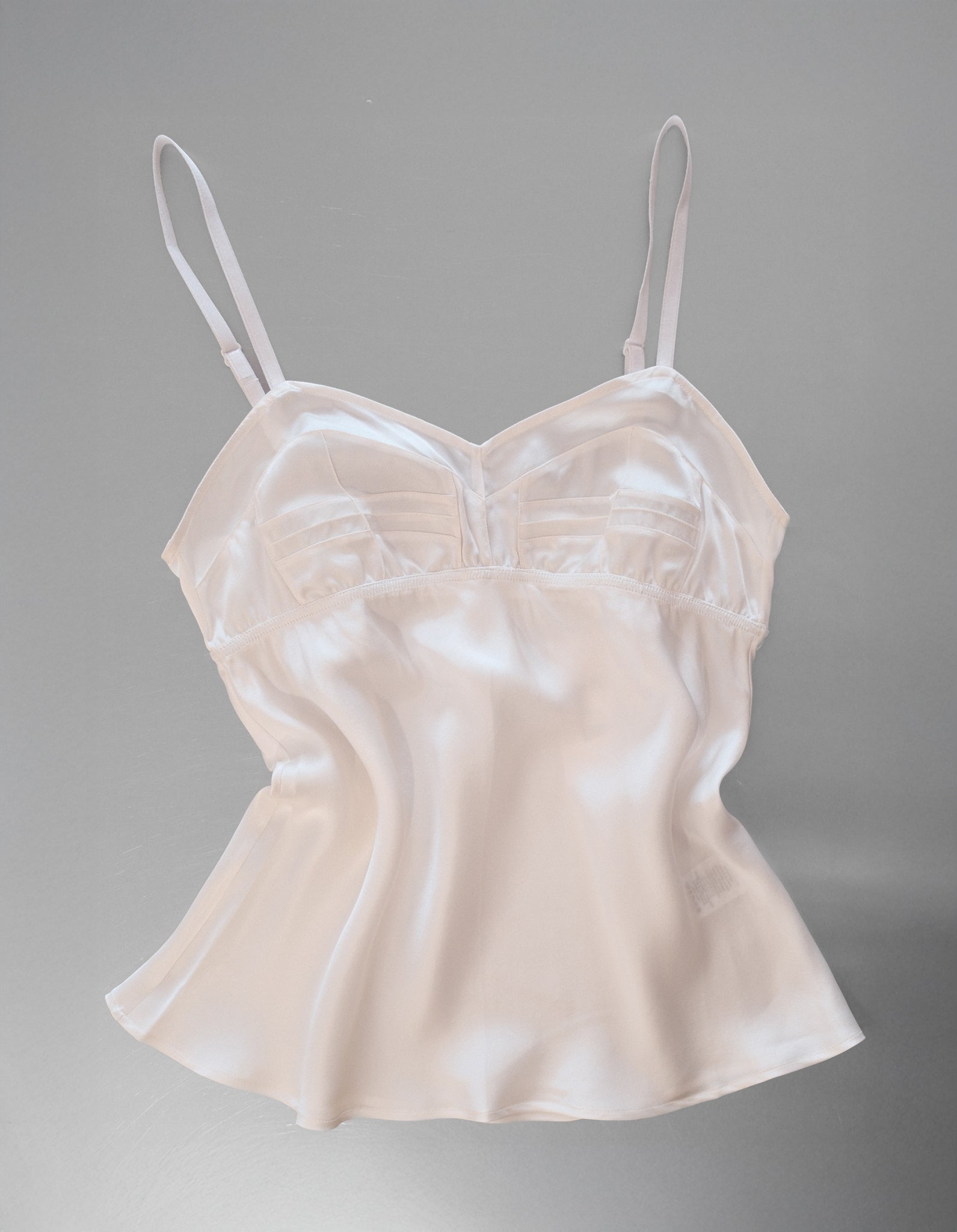White Cami with white straps on a metal table