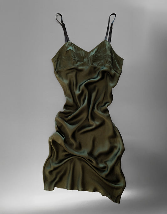 Green satin slip dress on a gray background