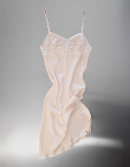 Beige slip dress on a gray background