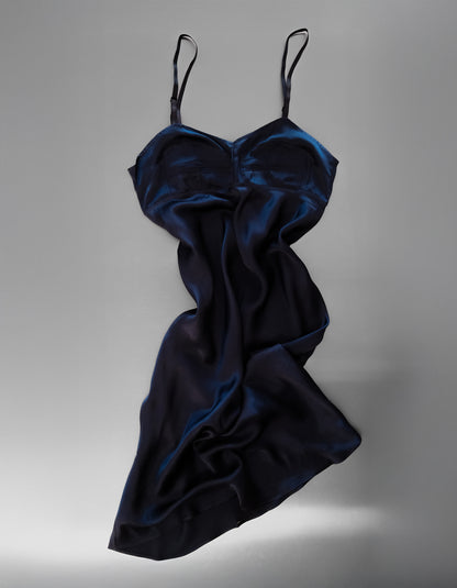 Navy blue satin slip dress on a gray background