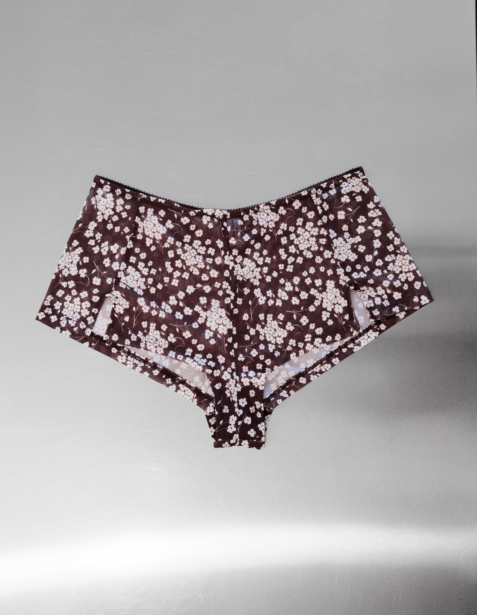 Floral Mesh Shorts on grey background