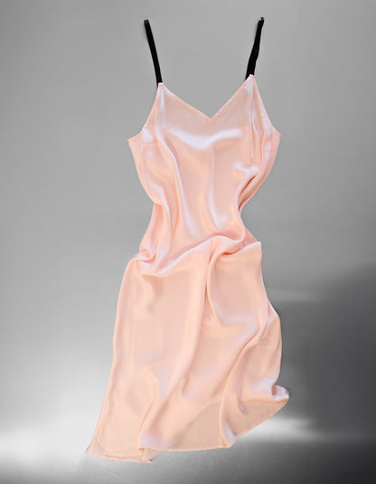 Light pink slip dress on a gray background