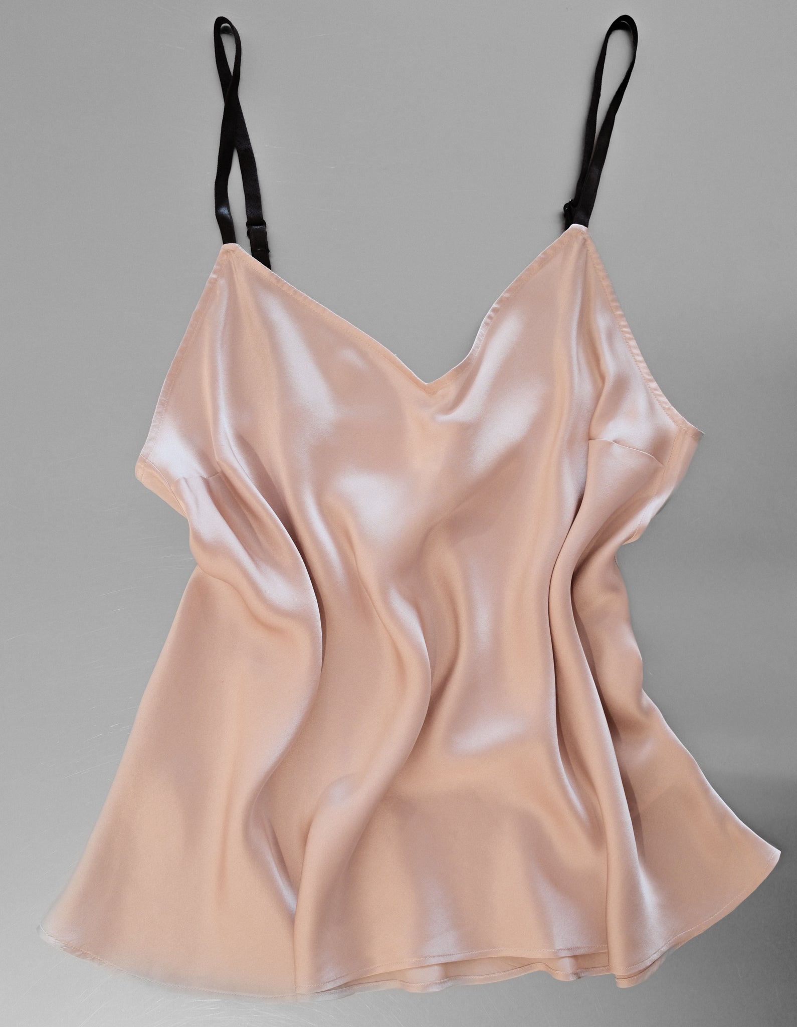 Beige satin camisole on a gray background