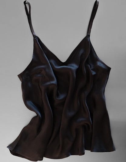 Black satin slip dress on a gray background