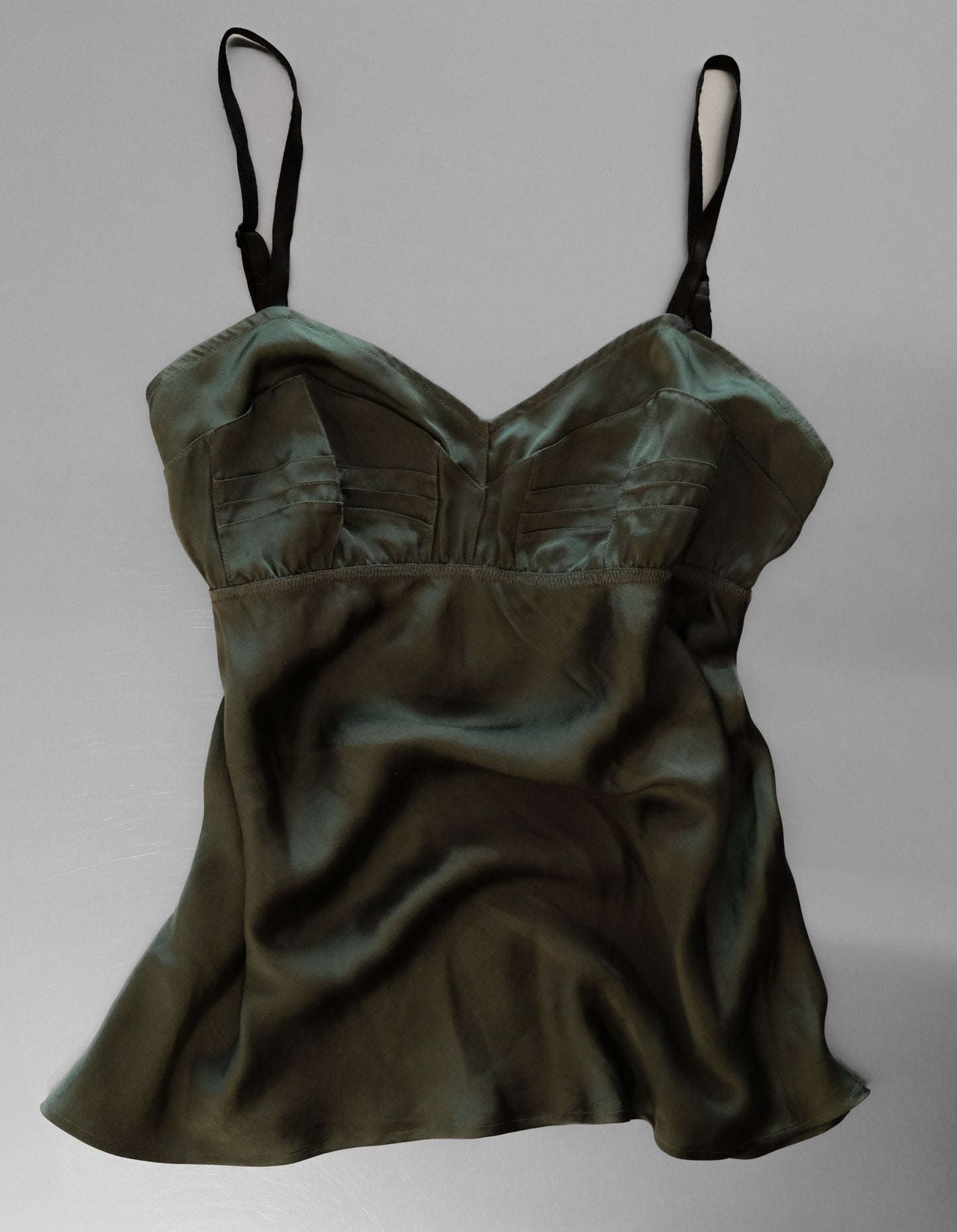 Green satin camisole on a gray background