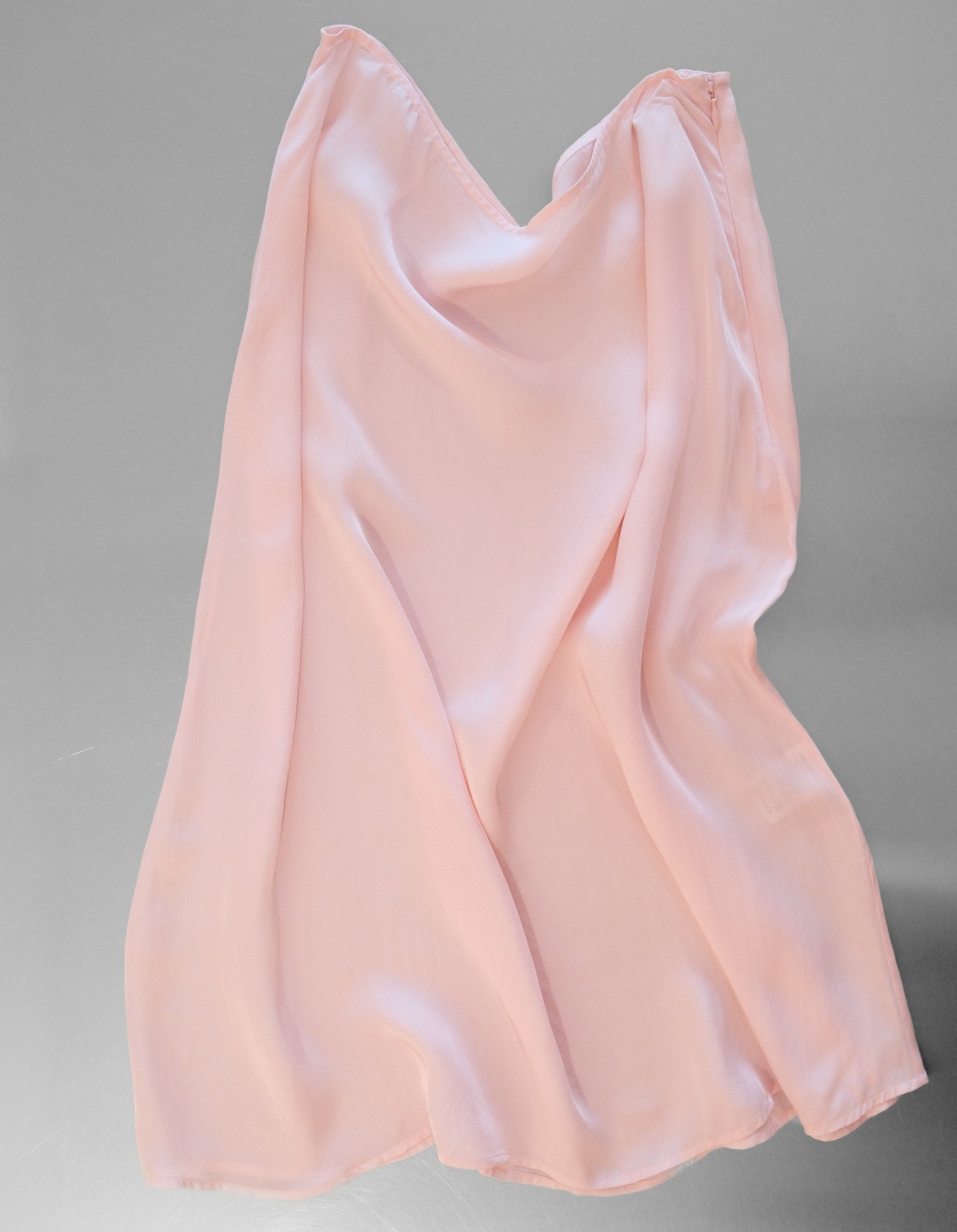 Pink satin skirt on a gray background
