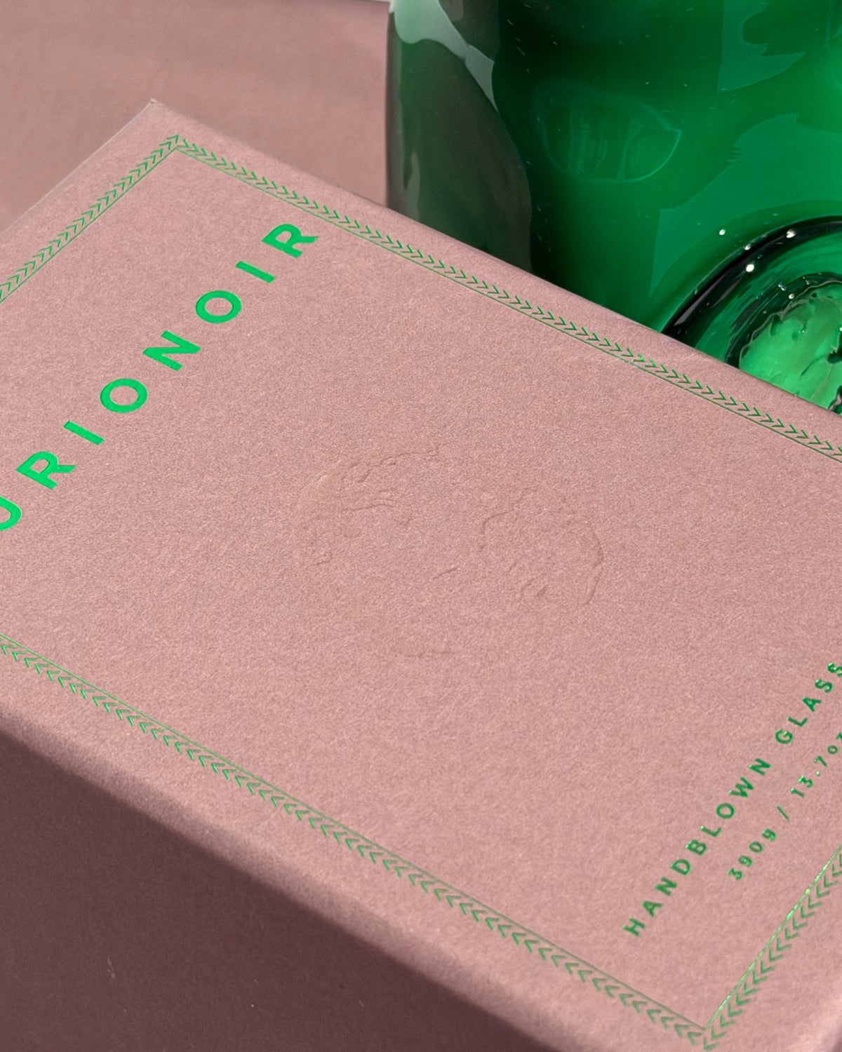 curionoir candle box close up with green glass in background