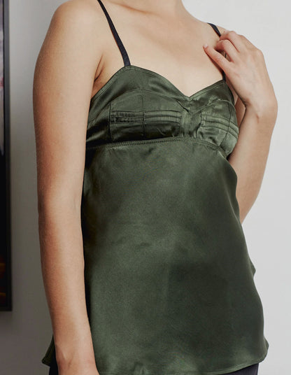 Green satin camisole worn by a person against a neutral background